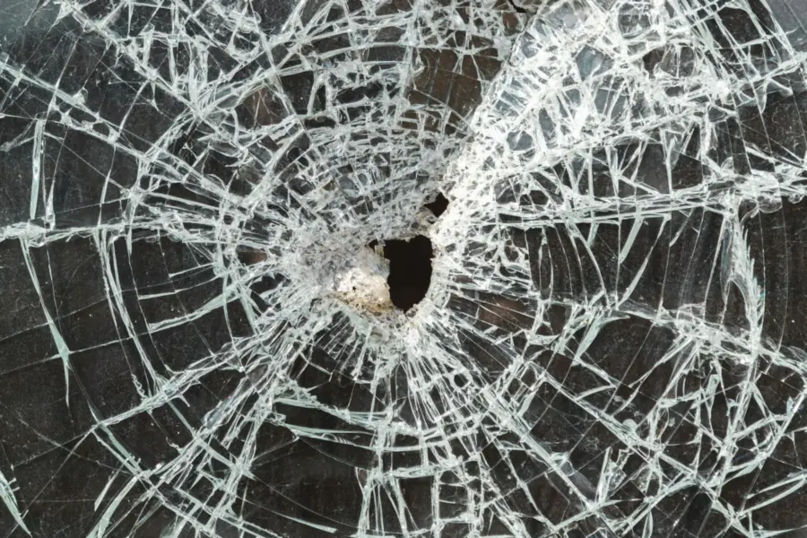 Cracked auto glass with an impact hole in Satellite Beach