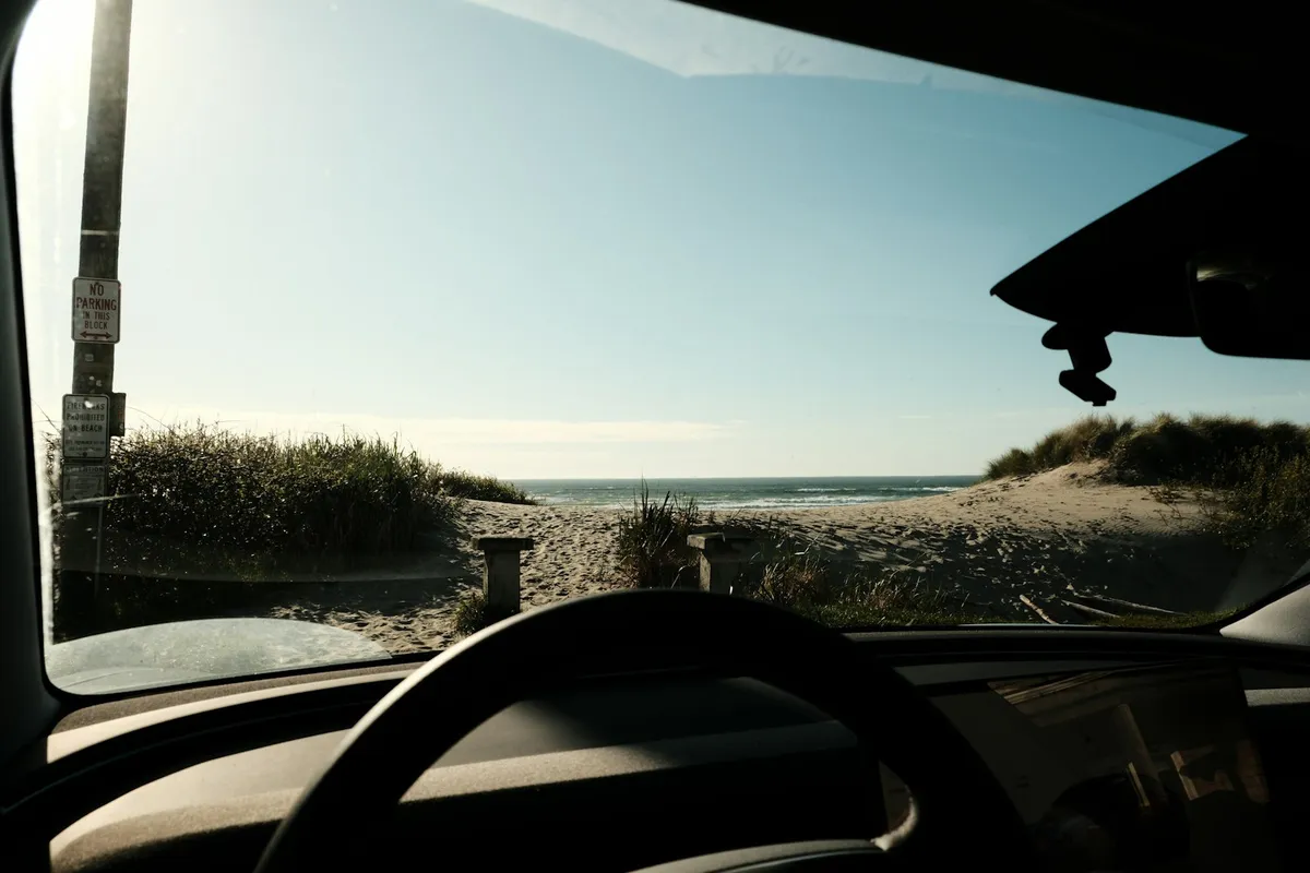 Ocean and dunes seen through a car windshield in Satellite Beach